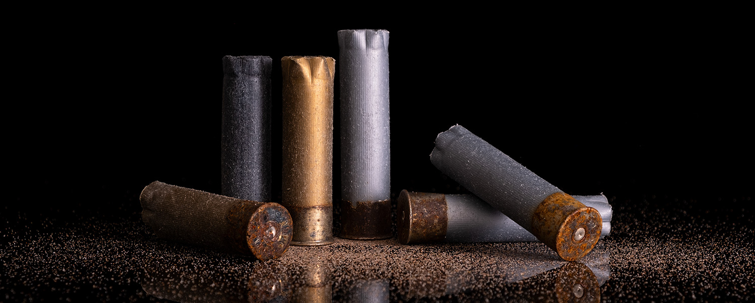 Still life of gun shot shells on reflective black background