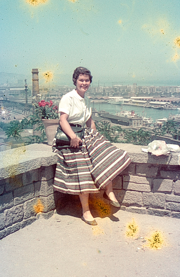 woman on wall with city behind, Europe 1956 - damaged slide