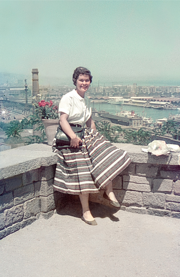 woman on wall with city behind, Europe 1956 - fixed slide
